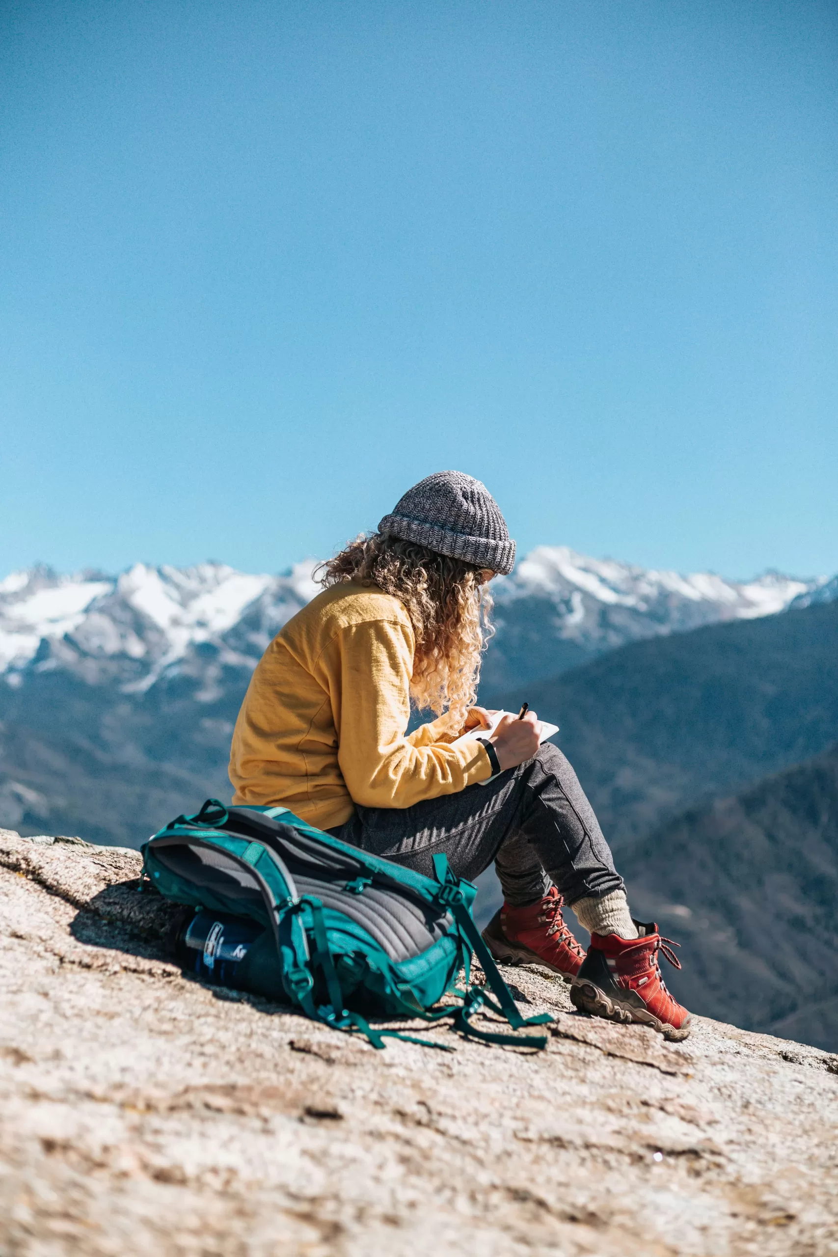 a girl traveling in the mountains, journaling prompts for self-discovery feature image